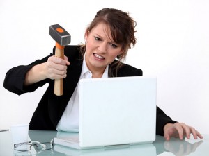 women with hammer about to smash apple computer